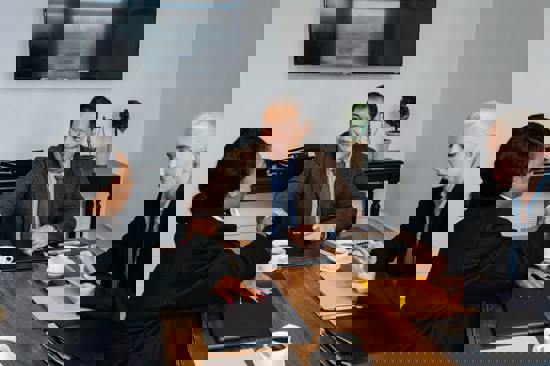 Image depicting a board meeting with three members